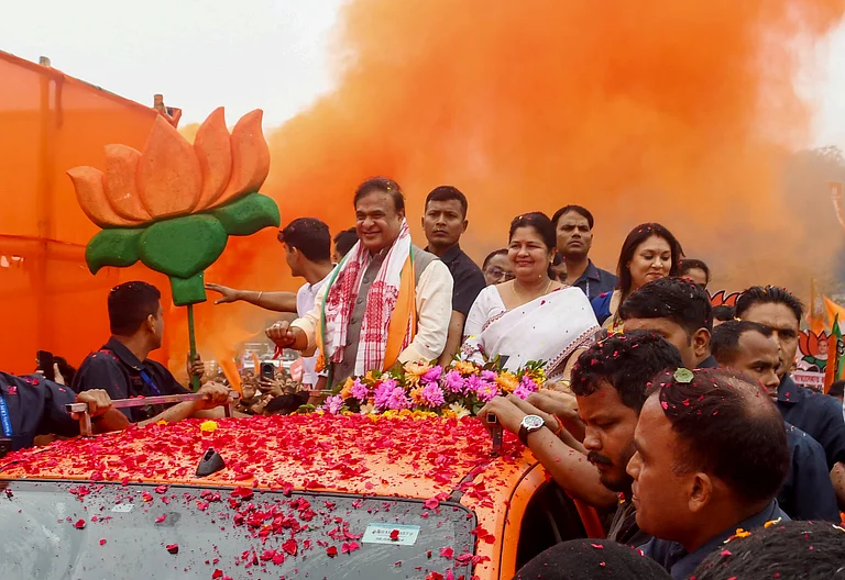 Assam Chief Minister Himanta Biswa Sarma takes part in a rally en route to file the nomination for the Jalukbari constituency ahead of the Assam Assembly elections, in Guwahati on Friday. - -