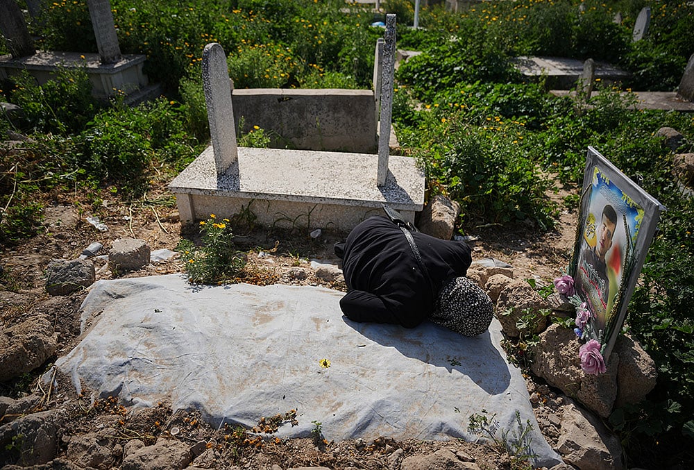 Eid al-Fitr 2026 in Gaza-Riham Yassin visits the grave of her son, Abdullah Yassin