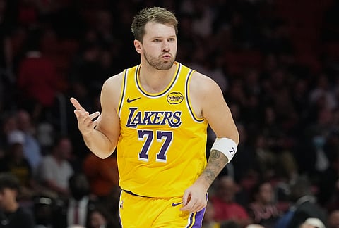 Los Angeles Lakers guard Luka Doncic (77) reacts after scoring during the second half of an NBA basketball game against the Miami Heat, in Miami.