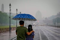 | Photo: PTI/Atul Yadav : Visitors make their way through the Kartavya Path amid rainfall, in New Delhi. The weather office has issued a yellow alert for the city. 