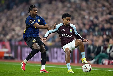 Lille's Nathan Ngoy, left, and Aston Villa's Ian Maatsen, right, challenge for the ball during the Europa League round of sixteen second leg soccer match between Aston Villa and LOSC Lille in Birmingham, England.
