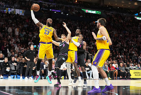 Los Angeles Lakers forward LeBron James (23) grabs a rebound during the second half of an NBA basketball game against the Los Angeles Lakers, in Miami.