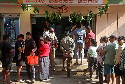 People gather outside a mutton shop for ‘Hosa Todaku’, a traditional festival celebrated on the day following Ugadi or the Kannada New Year, in Bengaluru.