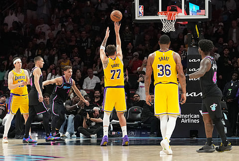 Los Angeles Lakers guard Luka Doncic (77) shoots a free throw to score sixty points during the second half of an NBA basketball game against the Miami Heat, in Miami.