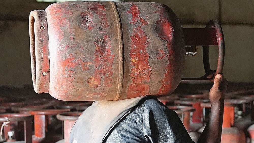 In Short Supply: A man carrying an LPG cylinder at an HP agency in Uttar Pradesh amid the ongoing crisis - | Photo: Tribhuvan Tiwari