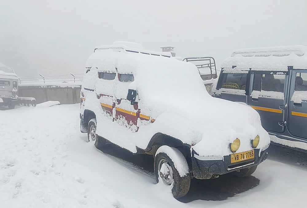 Snow covers vehicles, at Sandakphu area in Darjeeling district, West Bengal. - | Photo: PTI