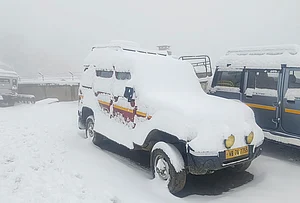 | Photo: PTI : Snow covers vehicles, at Sandakphu area in Darjeeling district, West Bengal.