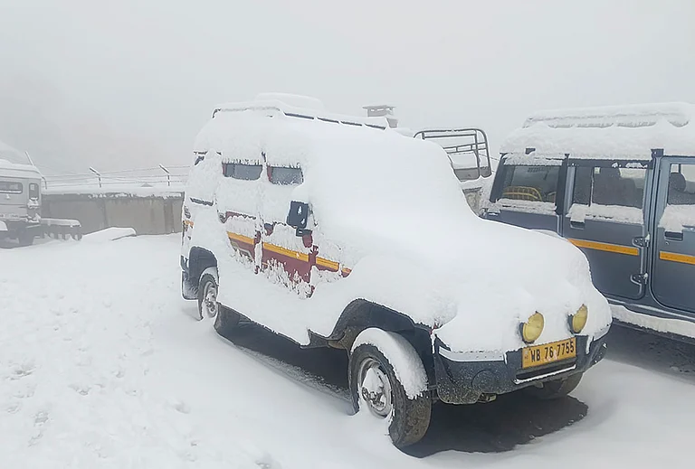 Snow covers vehicles, at Sandakphu area in Darjeeling district, West Bengal. - | Photo: PTI