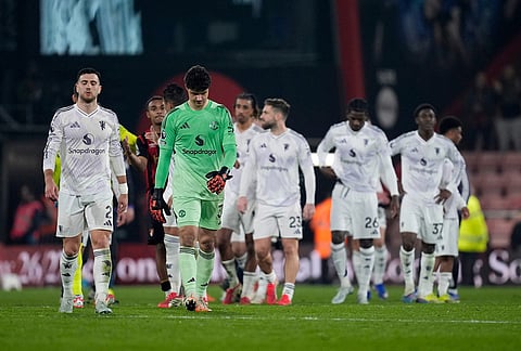 Manchester United players walk off the pitch following an English Premier League soccer match against AFC Bournemouth, in Bournemouth, England.