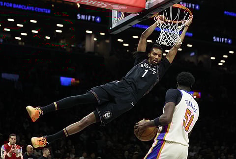 Brooklyn Nets forward Ziaire Williams (1) dunks past New York Knicks forward Mohamed Diawara (51) during the first half of an NBA basketball game, in New York. 