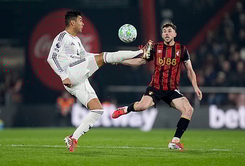 Manchester United's Casemiro, left, controls the ball in front of and Bournemouth's Ryan Christie  during an Premier League soccer match, in Bournemouth, England. 