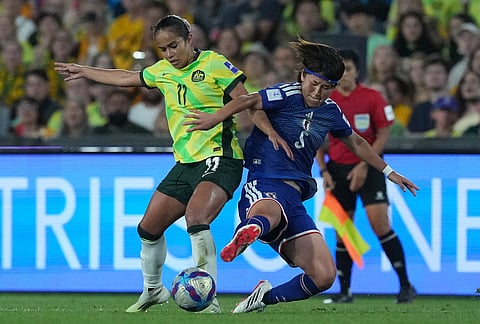 Australia's Mary Fowler, left, competes for the ball against Japan's Hana Takahashi during the Women's Asian Cup soccer final between Japan and Australia in Sydney.