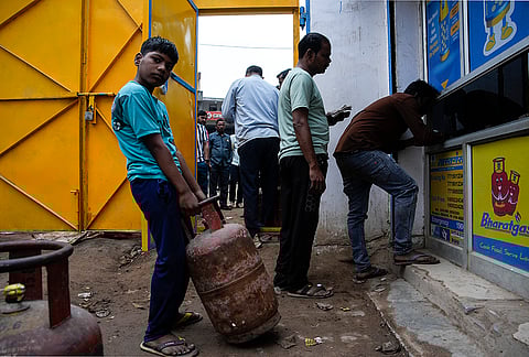 Residents of Badhkal, rural Faridabad, line up and wait at a distribution agency for LPG cylinders