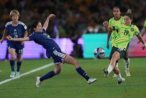 Japan's Hikaru Kitagawa, left, competes for the ball against Australia's Katrina Gorry during the Women's Asian Cup soccer final between Japan and Australia in Sydney.