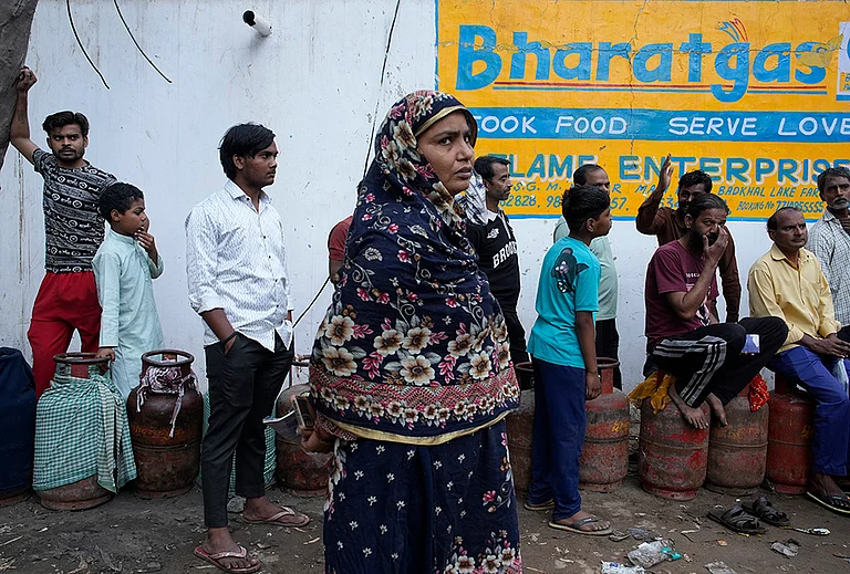 Residents of Badhkal in rural Faridabad, line up and wait at a distribution agency for LPG cylinders - | Photo: Vikram Sharma