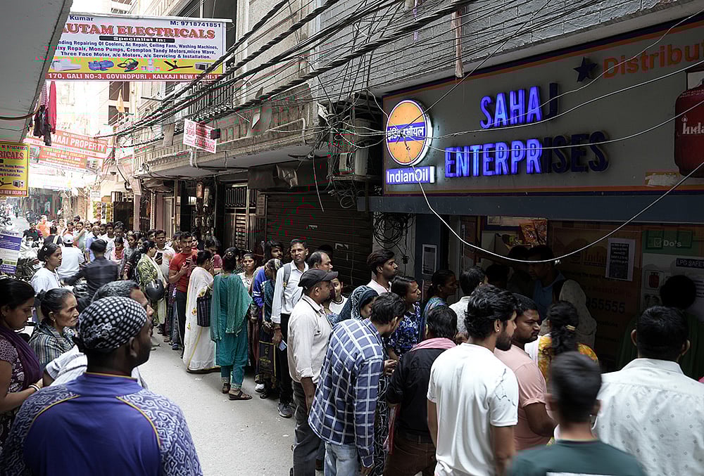 People queue up for LPG cylinder at an Indian Oil gas supply agency