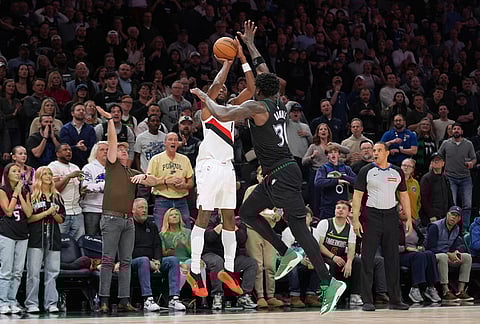 Portland Trail Blazers forward Jerami Grant (9) shoots over Minnesota Timberwolves forward Julius Randle (30) during the second half of an NBA basketball game in Minneapolis.