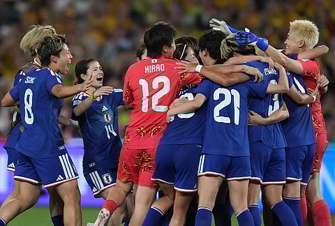 Japan players celebrate during the Women's Asian Cup soccer final between Japan and Australia in Sydney.