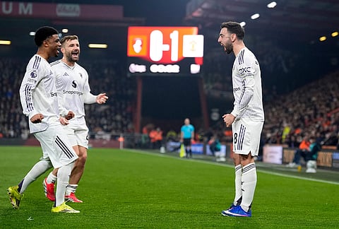 Manchester United's Bruno Fernandes, right, celebrates scoring during an Premier League soccer match against AFC Bournemouth, in Bournemouth, England. 
