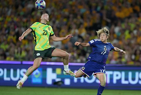 Japan's Maika Hamano, right, battles for the ball against Australia's Kyra Cooney-Cross during the Women's Asian Cup soccer final between Japan and Australia in Sydney.