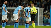 Man City Vs Crystal Palace Postponed: Why Is The English Premier League Match Not Being Played? | Photo: AP/Dave Thompson : Referee Clement Turpin talks with Manchester City's Bernardo Silva before checking the VAR for a red card during the Champions League round of 16 second leg soccer match between Manchester City and Real Madrid in Manchester, Tuesday, March 17, 2026.