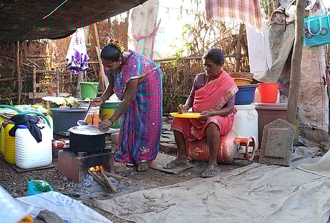 Nanu Bai Sohale (62) prepares food on a traditional wood-fired stove as her daughter Vanita Panchal (42) helps. Many families are turning to traditional cooking methods such as the wood-fired stove amid the ongoing shortage. 