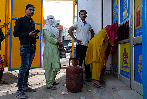 Residents of Badhkal, rural Faridabad, line up and wait at a distribution agency for LPG cylinders