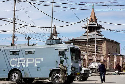 A security personnel stands guard as Eid prayers are not allowed at Srinagar's Jama Masjid, in Srinagar, Jammu and Kashmir.