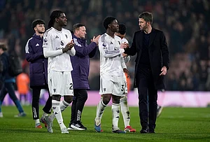 | Photo: Andrew Matthews/PA via AP : Manchester United manager Michael Carrick and Kobbie Mainoo shake hands following an English Premier League soccer match against AFC Bournemouth, in Bournemouth, England.