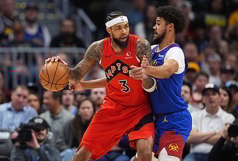 Toronto Raptors forward Brandon Ingram, left, works against Denver Nuggets forward Cameron Johnson in the first half of an NBA basketball game in Denver.