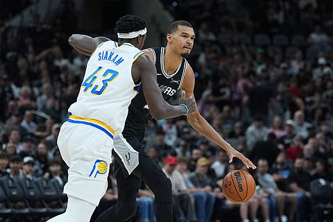 San Antonio Spurs forward Victor Wembanyama (1) drives around Indiana Pacers forward Pascal Siakam (43) during the first half of an NBA basketball game in San Antonio.