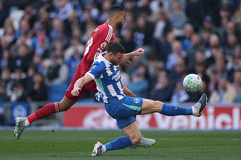 Liverpool's Cody Gakpo, left, and Brighton's James Milner fight for the ball during the English Premier League soccer match between Brighton and Liverpool in Brighton.