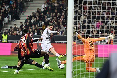 PSG's Khvicha Kvaratskhelia, center, gets in a shot during the French League One soccer match between Nice and Paris Saint-Germain in Nice, France.