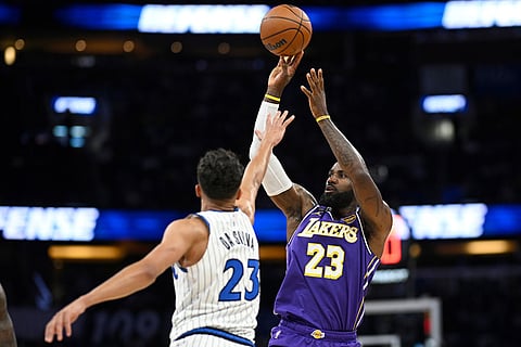 Los Angeles Lakers forward LeBron James (23) goes up to shoot as Orlando Magic forward Tristan da Silva, left, defends during the first half of an NBA basketball game  in Orlando, Fla.