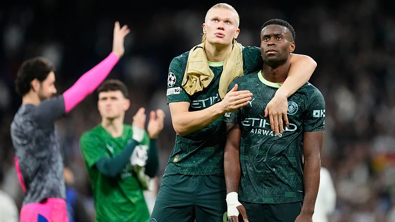 Manchester City's Erling Haaland, left, and Marc Guehi walk off the pitch after a first leg round of 16 Champions League soccer match between Real Madrid and Manchester City in Madrid, Spain, Wednesday, March 11, 2026. - | Photo: AP/Jose Breton