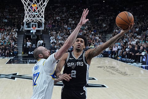 San Antonio Spurs guard Dylan Harper (2) drives to the basket against Indiana Pacers center Jay Huff (32) during the first half of an NBA basketball game in San Antonio.