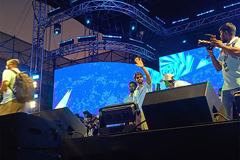 T20 World Cup winner and Mumbai Indians batter Tilak Varma waves to the fans inside the Mix event.