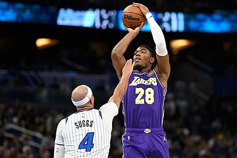 Los Angeles Lakers forward Rui Hachimura (28) goes up to shoot as Orlando Magic guard Jalen Suggs (4) defends during the first half of an NBA basketball game in Orlando, Fla.