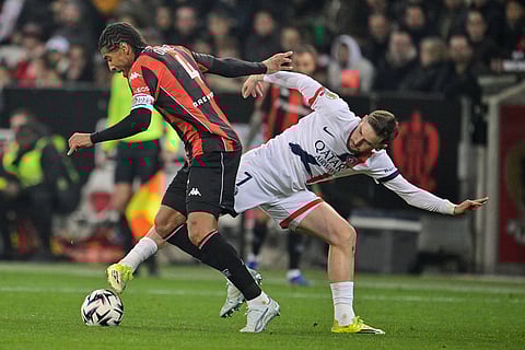 PSG's Khvicha Kvaratskhelia, right, and Nice's Dante battle for the ball during the French League One soccer match between Nice and Paris Saint-Germain in Nice, France.