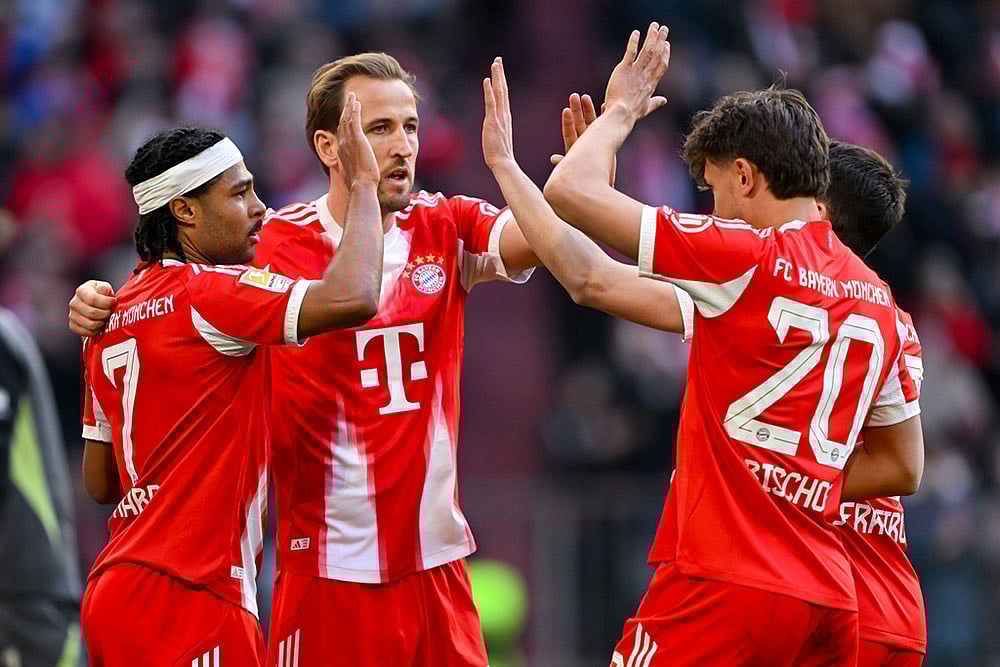 From left, Munich's scorer Serge Gnabry, Harry Kane, Tom Bischof and Raphael Guerreiro celebrate their side's fourth goal during the German Bundesliga soccer match between FC Bayern Munich and 1. FC Union Berlin in Munich, Germany. - | Photo: Sven Hoppe/DPA via AP