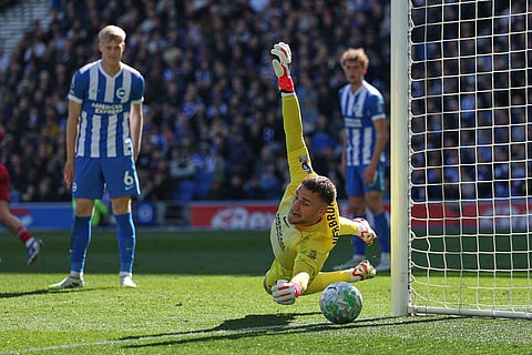 Brighton's goalkeeper Bart Verbruggen dives during the English Premier League soccer match between Brighton and Liverpool in Brighton.