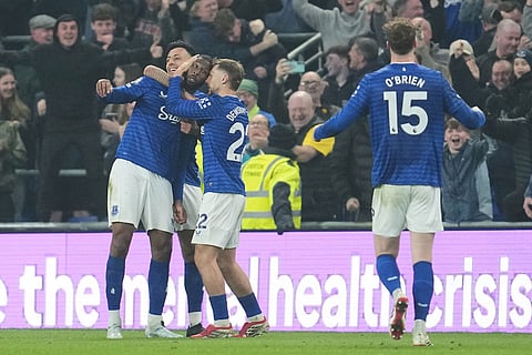 Everton's Beto celebrates with teammates after scoring his side's second goal during the English Premier League soccer match between Everton and Chelsea in Liverpool, England.