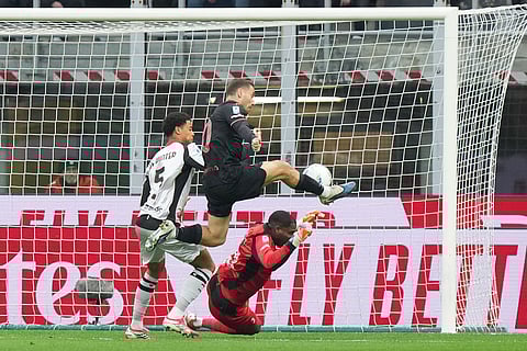 Torino's Nikola Vlasic, top, attempts a shot on goal during the Serie A soccer match between AC Milan and Torino, in Milan, Italy.