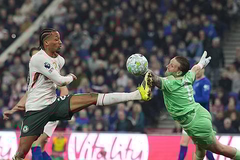 Chelsea's Joao Pedro, left, makes an attempt to score past Everton's goalkeeper Jordan Pickford during the English Premier League soccer match between Everton and Chelsea in Liverpool, England.