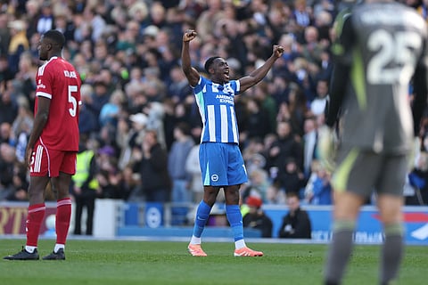 Brighton's Danny Welbeck celebrates after scoring during the English Premier League soccer match between Brighton and Liverpool in Brighton.