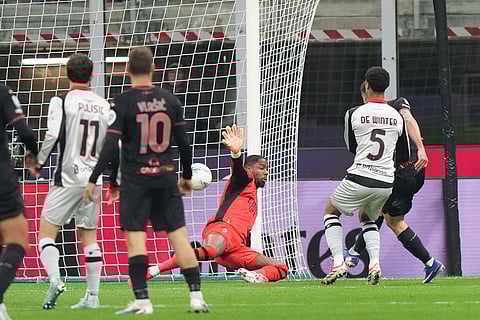 AC Milan's goalkeeper Mike Maignan, center, fails to block a shot by Torino's Giovanni Simeone to score his side's first goal during the Serie A soccer match between AC Milan and Torino, in Milan, Italy.