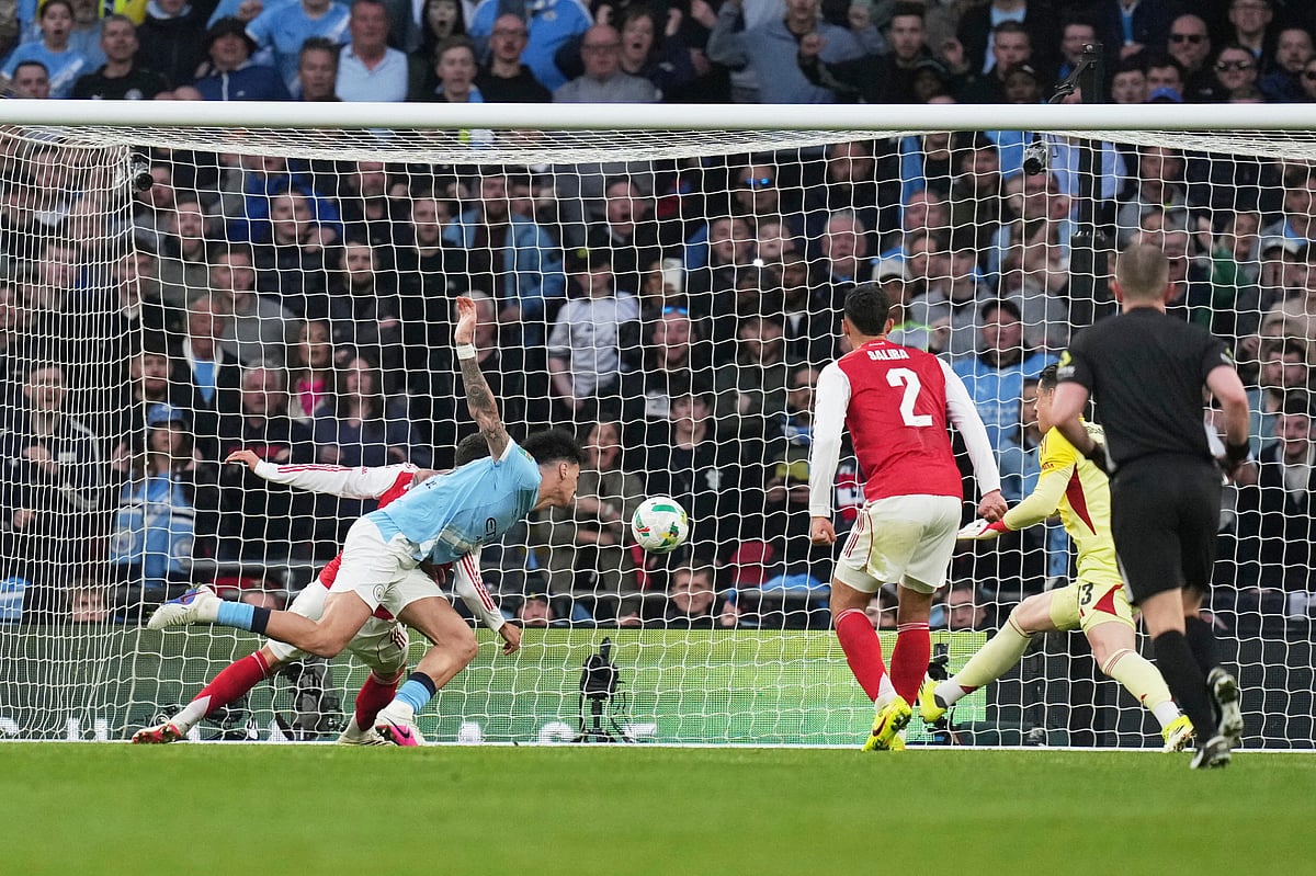 Manchester City's Nico O'Reilly, heads the ball and scores the opening goal during the English League Cup final soccer match between Arsenal and Manchester City in London, Sunday, March 22, 2026.