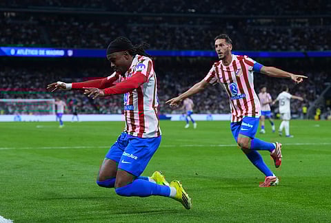 Atletico Madrid's Ademola Lookman, left, celebrates with Koke after scoring the opening goal during the Spanish La Liga soccer match between Real Madrid and Atletico Madrid in Madrid, Spain.