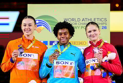 Devynne Charlton, of Bahamas, center, Nadine Visser, of the Netherlands, left, and Pia Skrzyszowska, of Poland, pose on the podium after winning medals in the women's 60 meters hurdles at the World Athletics Indoor Championships in Torun, Poland.