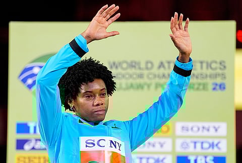 Devynne Charlton, of Bahamas, poses on the podium after winning a gold medal in the women's 60 meters hurdles at the World Athletics Indoor Championships in Torun, Poland.